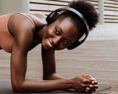 A woman with headphones listens to Audible.