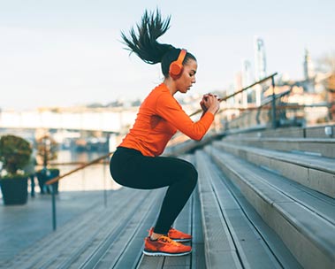 A woman with headphones listens to Audible.