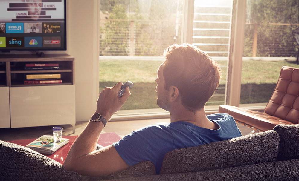 Man using voice remote in living room