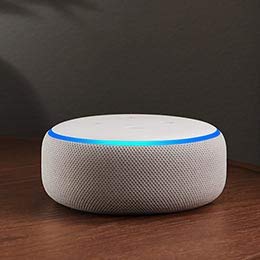 Image of a black Echo Plus device on a side table.