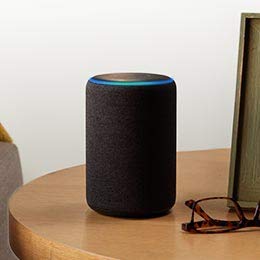 Image of a black Echo Plus device on a side table.