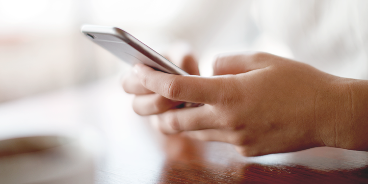 Hands holding mobile phone