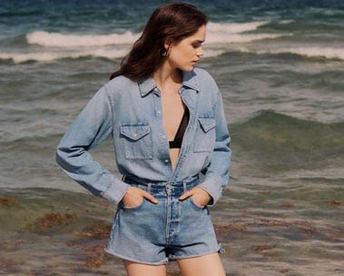 Woman in denim shirt and shorts