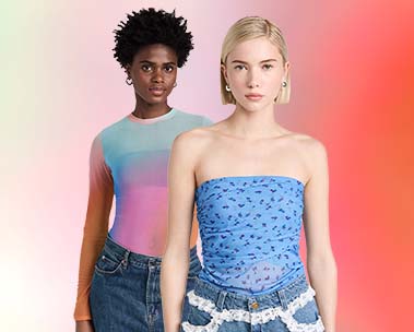 Girl up front with blonde bob in blue mesh tube top and jeans with white ruffles and girl in the back in a rainbow mesh long sleeve and dark jeans with short dark hair on red ombre background