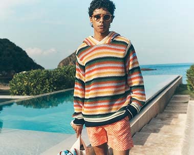 man in colorful hoodie by pool