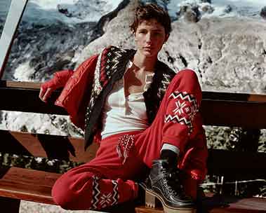 woman in red ski suit sitting