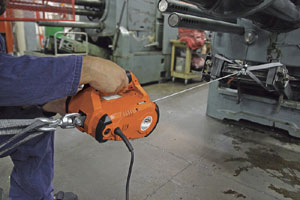 Warn Works 685000 PullzAll 110V AC Corded Electric Pull Tool used to pull an item in a shop setting