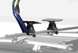 Close-up image of the two saddles and attachment strap of the Thule 875XT Hydro-Glide XT Rooftop Kayak Carrier securing a kayak in place