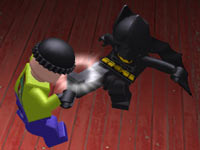 Batman kicking a henchman in Lego Batman 2: DC Super Heroes for PS Vita