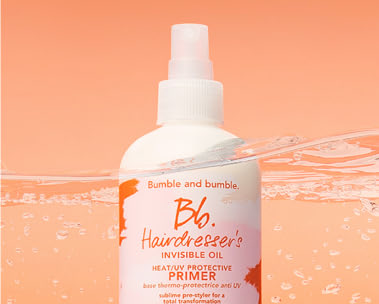 Bumble and bumble. 8.5 oz hairdresser's invisible oil primer white bottle floating slightly above water, featured against an orange background.