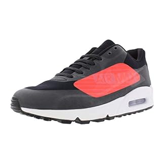 Black and red Nike Men’s Air Max 90 Essential low-top sneakers with visible air cushioning, featuring a sleek design and sturdy sole.