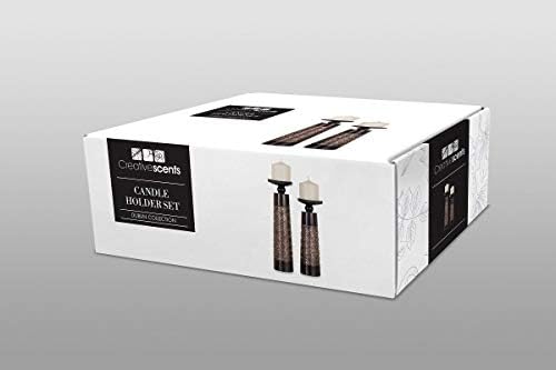 Ornamental candle set on a desk, featuring a decorative candle holder.