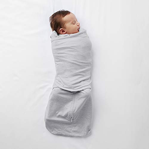 Two arms holding a sleeping child wrapped in a cotton hip carrier, priced at $21.00.