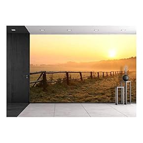 Sunrise Over Misty Grassland with Wooden Fence in The Foreground - Removable Wall Mural | Self-Adhesive Large Wallpaper - 66x96 inches