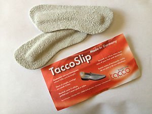 A PAIR OF TACCOSLIP TACCO SLIP FOOTCARE HEEL PROTECTORS. HEEL GRIPS HEEL GRIP SMOOTH AS VELVET. LIGHT GRAY COLOR. SUEDE LIKE TEXTURE. STOPS HEELS FROM SLIPPING. MADE IN GERMANY.