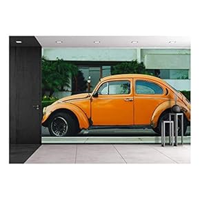Antique Orange Car Parked in Front of a Building - Removable Wall Mural | Self-Adhesive Large Wallpaper - 66x96 inches