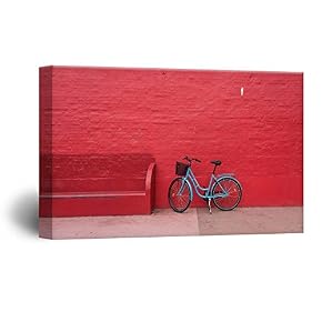 A Blue Bike in Front of a Red Wall