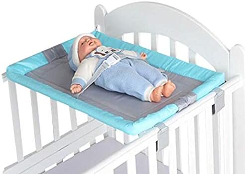 changing baby on bed