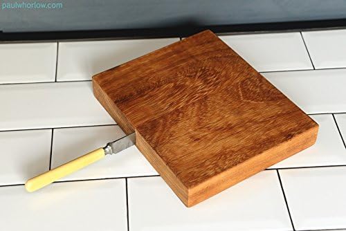 Eco-friendly, unique, handmade Iroko hardwood serving or chopping board with an upcycled bread knife as a handle