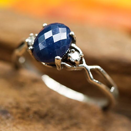 Faceted blue sapphire ring with diamond side set gems in prongs setting with sterling silver high polish band