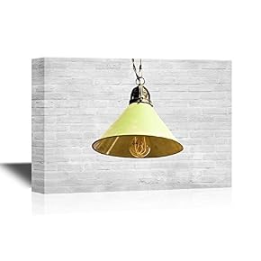 Yellow Light Bulb Against White Brick Background