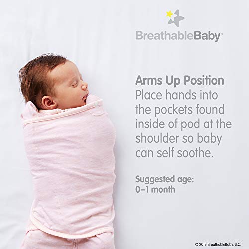 Child sleeping in cotton hip carrier, arms wrapped securely.