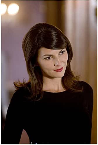 Leverage Sophie Devereaux in black standing, smiling with head tilted