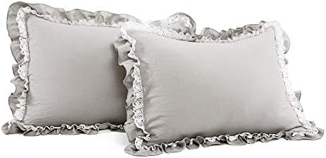 White lace ruffle comforter set on a bed.