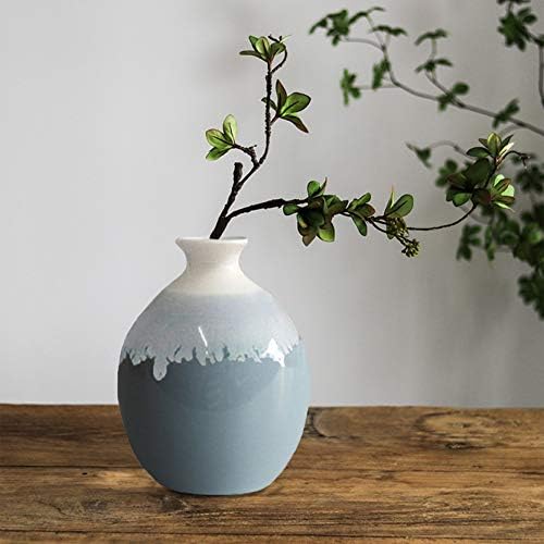 Blue ceramic vase with intricate design, 9 inches tall, priced at $32.99.