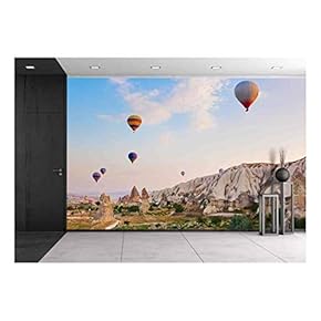 Hot Air Balloon Flying Over Rock Landscape at Cappadocia Turkey - Removable Wall Mural | Self-Adhesive Large Wallpaper - 66x96 inches