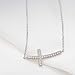 LAVISHE Rhodium Plated 925 Sterling Silver Cubic Zirconia Small Curved Sideways Cross Necklace for Women, 18 inch