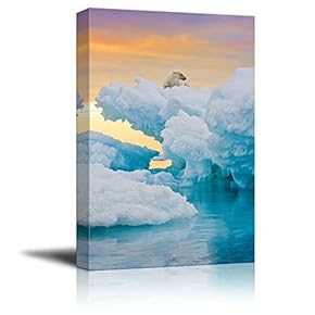 Polar Bear Sitting on Frozen Ice Outcrop Vertically Framed Shot