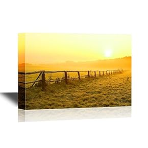 Sunrise Over Misty Grassland with Wooden Fence