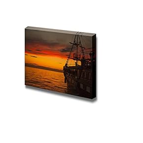 Old Fashion Sail Boat Near Harbor at Sunset...