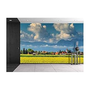 Spectacular Village with Canola Field and Cloudy Mountains in Background Near Brasov,Transylvania,Romania,Europe - Removable Wall Mural | Self-Adhesive Large Wallpaper - 66x96 inches