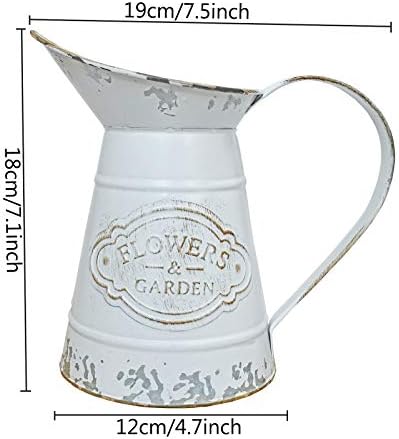 Tall glass vase with white flowers and decorative accents.