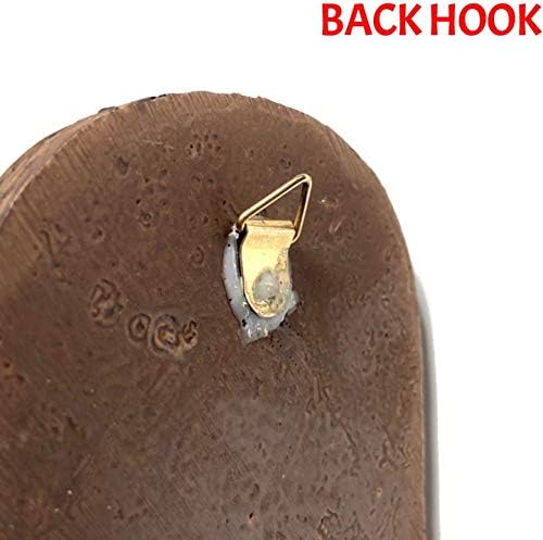 Colorful backyard gnome hanging on a tree branch.