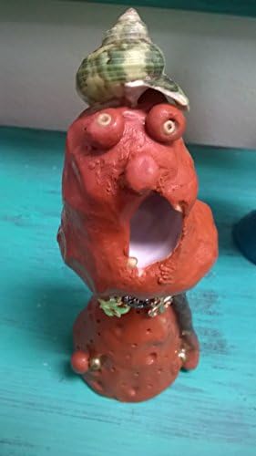 Sammy. Sea Monster Charm. A unique, one of a kind, hand sculptured gift. I'm brown with beady eyes and people say I look like a golfer. Maybe, I do have two balls. I have a greenish shell hat.