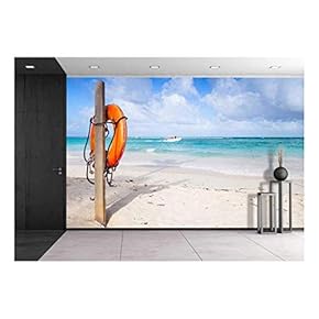 Red Round Life Buoy Hanging on Wooden Pole, Empty Sandy Beach of Dominican Republic - Removable Wall Mural | Self-Adhesive Large Wallpaper - 66x96 inches