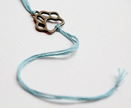 bronze pawprint wishlet with aqua thread
