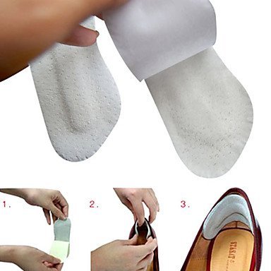 A PAIR OF TACCOSLIP TACCO SLIP FOOTCARE HEEL PROTECTORS. HEEL GRIPS HEEL GRIP SMOOTH AS VELVET. LIGHT GRAY COLOR. SUEDE LIKE TEXTURE. STOPS HEELS FROM SLIPPING. MADE IN GERMANY.