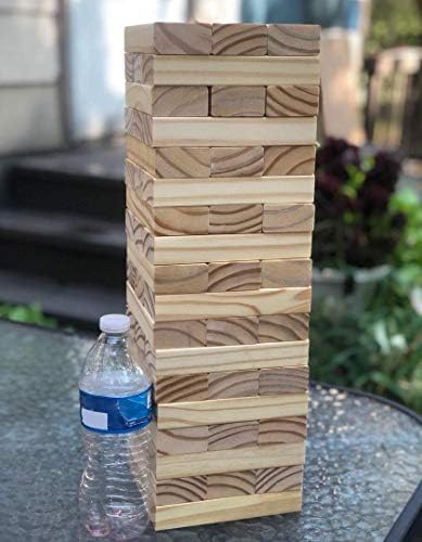 Wooden tower blocks game with a player removing a block from the tower, with a case and rules included, measuring inches.