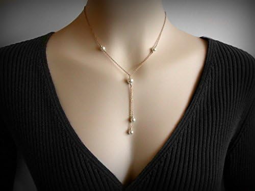 A lariat necklace, or"Y" necklace, with Swarovski faux pearls, in 14K yellow gold filled.