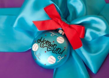 Coton Colors Painted Christmas Ornaments. The Glass 90mm Oval Baseball Ornament Is Designed with Three Baseballs Accented By Artistic Homerun! Writing on the Front and Features a Bat and Ball on the Back.