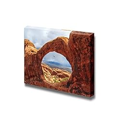 Beautiful Scenery Landscape Bird Flying Through The Top O of Double O Arch in Arches National Park Utah - Canvas Art Wall Art - 12" x 18"