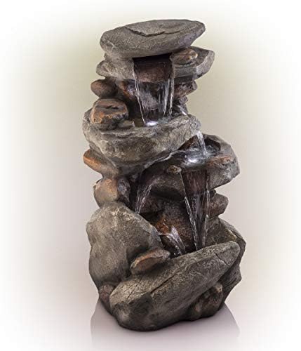 Backyard water fountain with doors setting, pump, and flowing water.