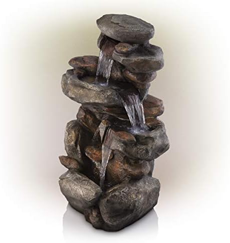 Backyard water fountain with doors setting, pump, and flowing water.