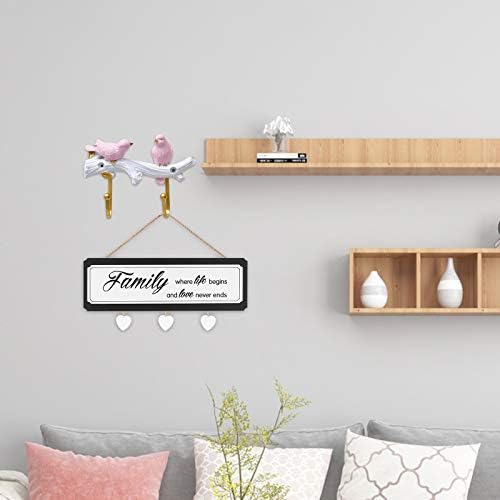 Colorful wooden sign with the phrase "Home Sweet Home" in white lettering, surrounded by small decorative elements.