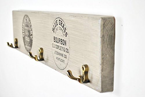 Wooden coat rack with vintage whiskey brand prints