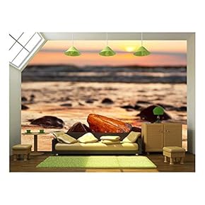 Amber Stone on The Beach at Sunset. Precious Gem, Treasure Concept. Baltic Sea, Poland. - Removable Wall Mural | Self-Adhesive Large Wallpaper - 66x96 inches